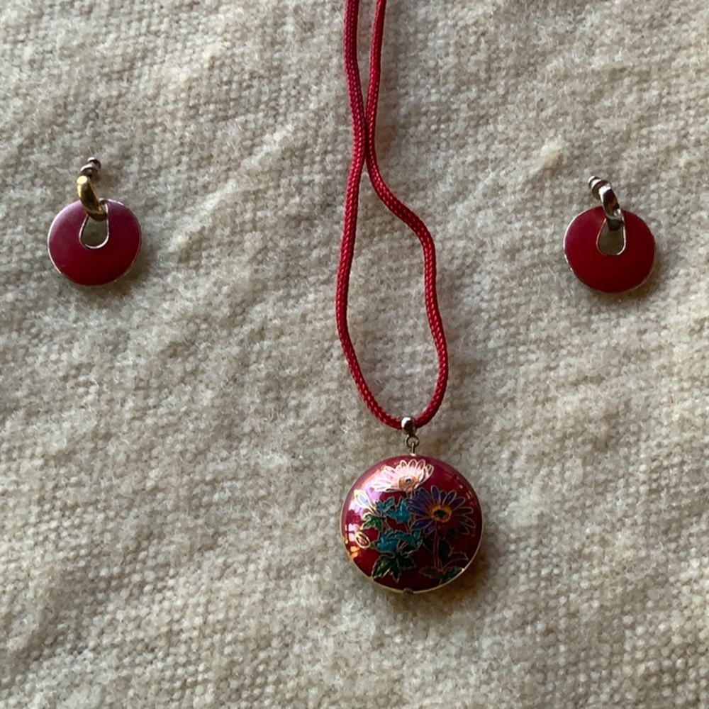 Enameled round charm on red ribbon cord necklace with red and gold earrings